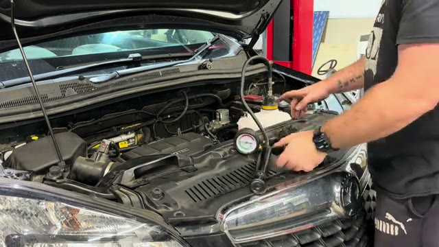 Re-testing the cooling system after the repair with the pressure gauge holding steady