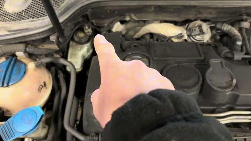 Oil film coating the top of the Audi A3 engine pointing to an air leak