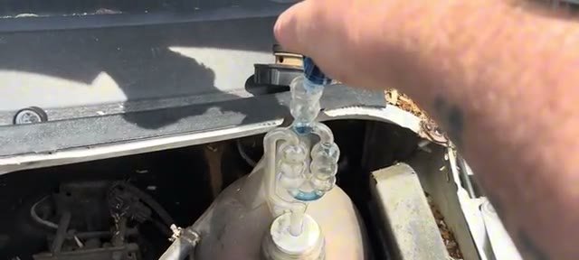 Filling the combustion leak tester chambers with blue test fluid