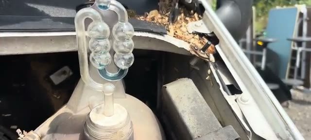 Block tester fitted to the coolant tank with the fluid still baseline blue