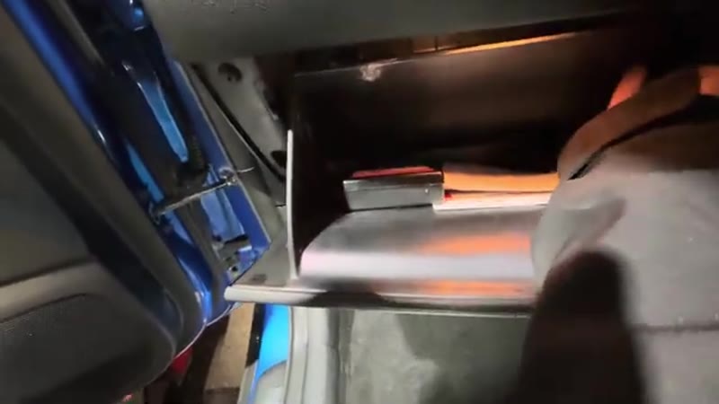 Untwisting one of the two side clips inside the Kia Sportage glove box