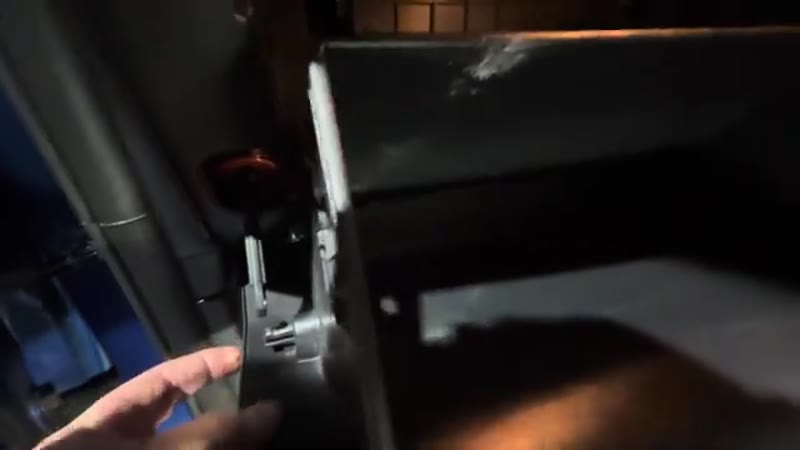Pinching the damper bar clip and pulling the bar off the side of the glove box