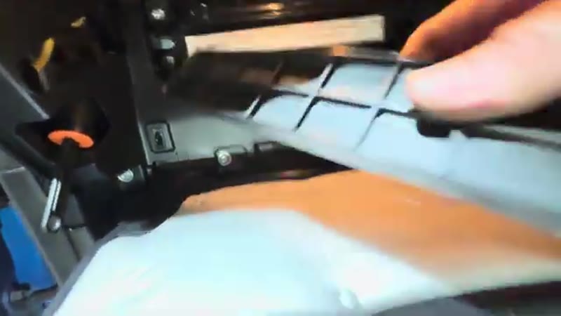 Opening the pollen filter trap door behind the glove box on the Kia Sportage