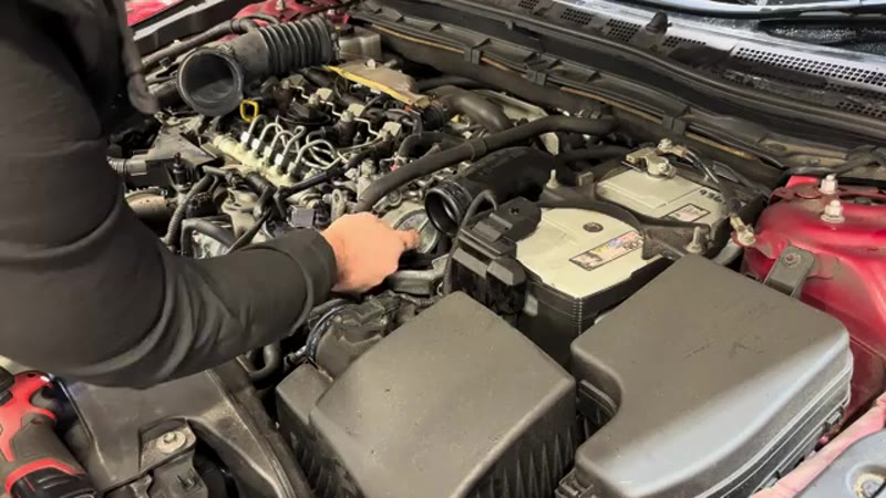 Removing the air intake pipe from the 2.2 SkyActiv diesel engine on a Mazda 3