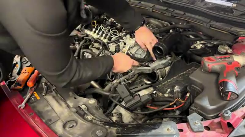 Undoing the four 10mm retaining bolts on the Mazda 3 vacuum pump