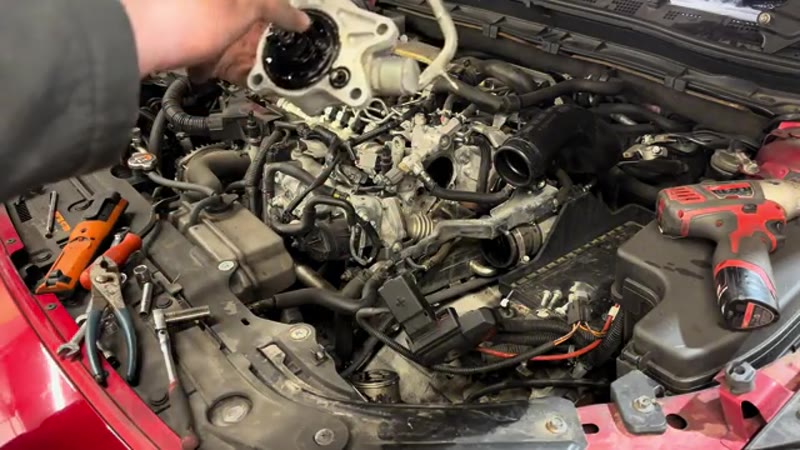 Old vacuum pump removed showing the clean mating face on the Mazda 3 engine
