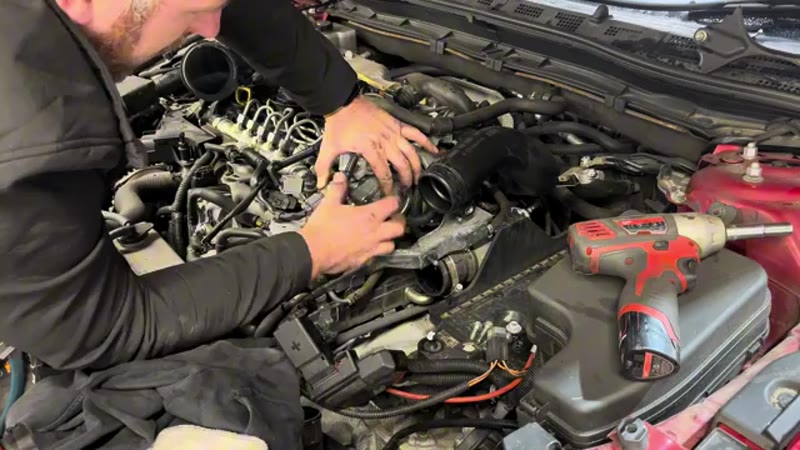 Fitting the new vacuum pump with a fresh gasket to the Mazda 3 engine