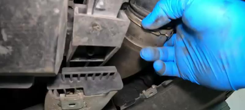 Releasing the metal clips to remove the boost pipe from underneath the Mercedes C220