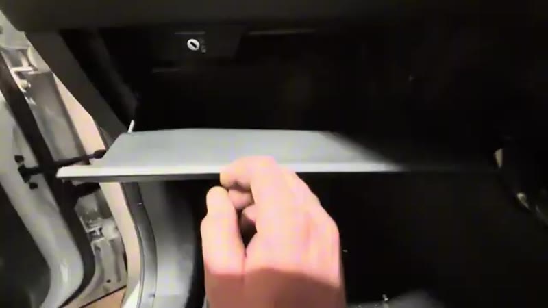 Opening the glove box on a 2021 MG ZS to reach the two retaining tabs