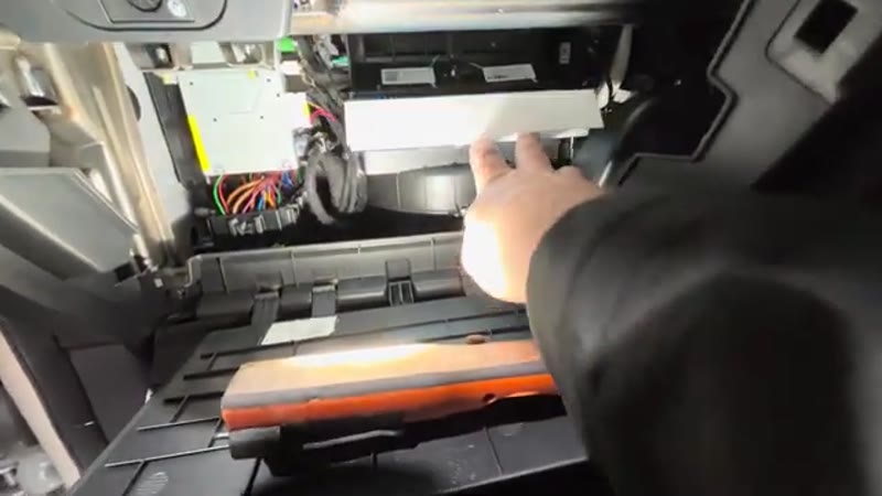 Pushing the new pollen filter into the housing on the MG ZS with the airflow arrow facing down