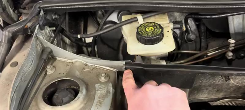 Pulling back the rubber trim to gain access to the brake master cylinder on a Mini Cooper