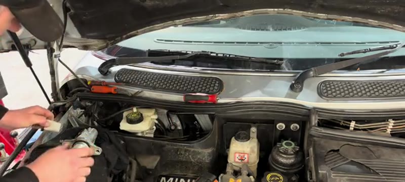Fitting the new master cylinder and starting the brake pipe unions by hand on the Mini Cooper