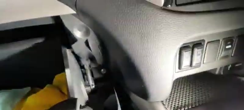 Glove box open on a Mitsubishi L200 showing the small damper on the side