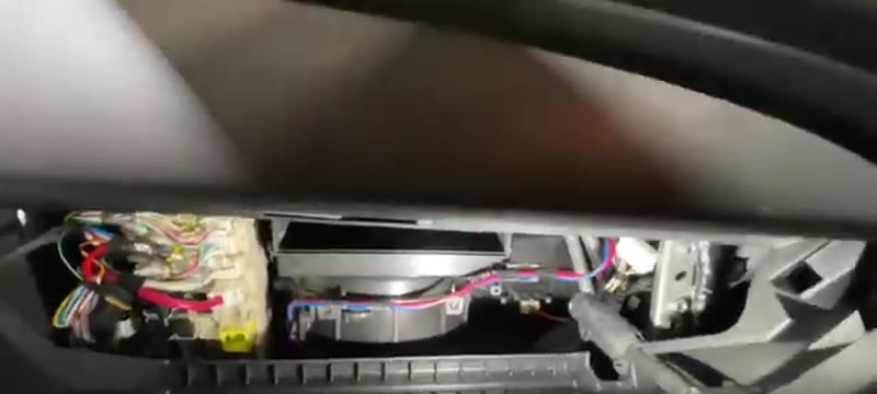 Pulling the old cabin filter out of the housing behind the glove box on the L200