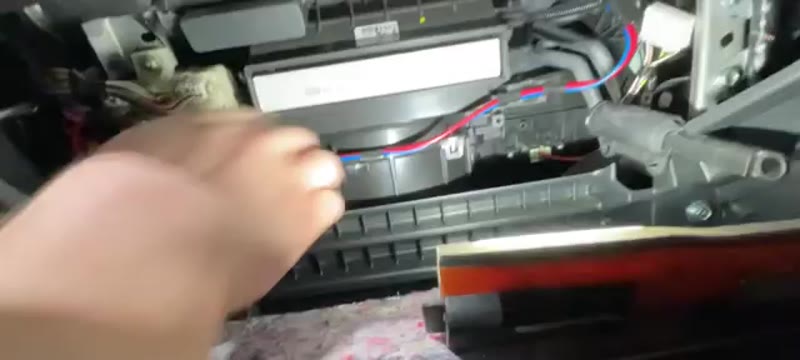 Sliding the new cabin filter into the Mitsubishi L200 housing with the airflow arrow facing down