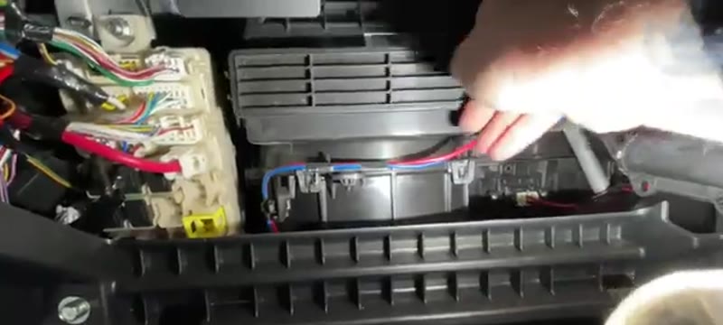 Clipping the filter cover back on before refitting the glove box and damper on the L200