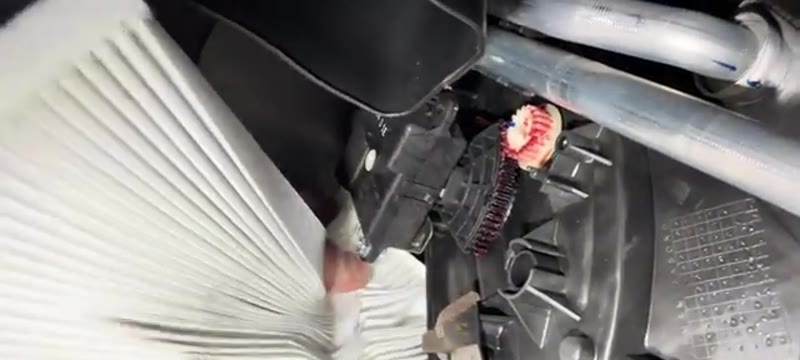 Checking the airflow direction arrow on the new pollen filter for the Qashqai