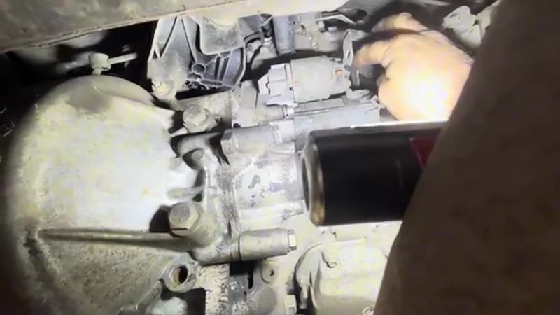 Disconnecting the cables from the starter motor terminals from underneath the Peugeot Expert