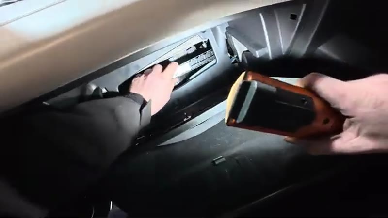 Opening the pollen filter trap door behind the glove box on a Range Rover Velar