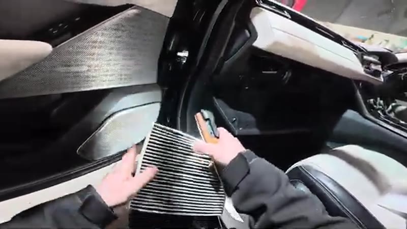 Sliding the old pollen filter out of the housing on a Range Rover Velar