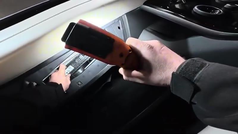 Clipping the filter trap door back into place behind the Velar glove box