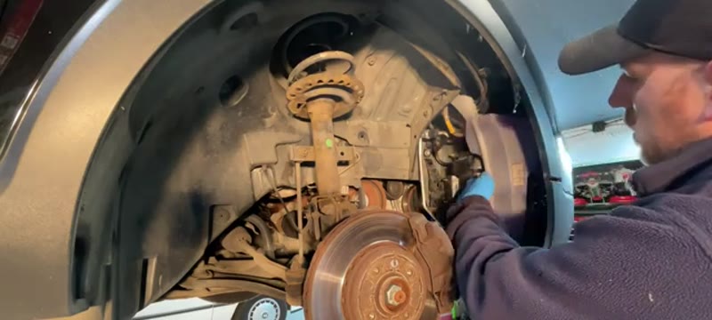 Undoing the 10mm bolts holding the fuel filter housing inside the Captur wheel well