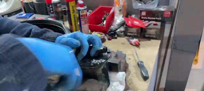 Removing the five T30 Torx bolts from the fuel filter housing lid