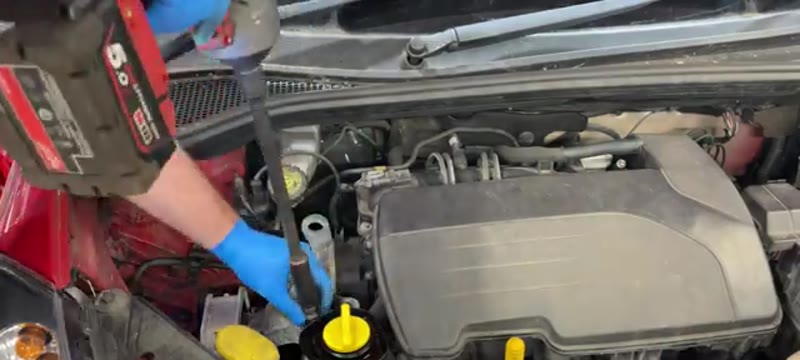 Undoing the engine mount bolts with the engine supported on a Renault Clio