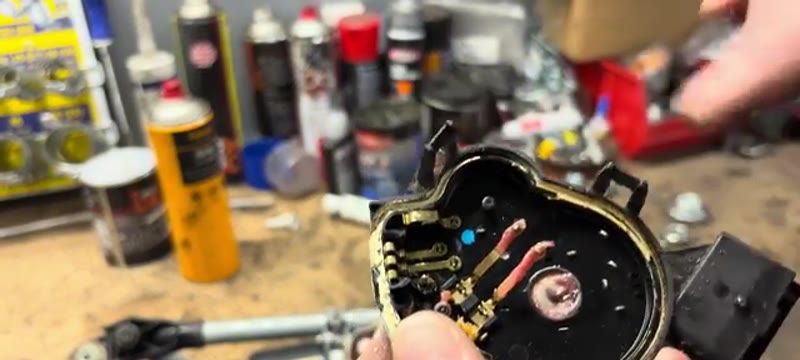 Inspecting the worm wheel and contacts inside the opened Megane wiper motor