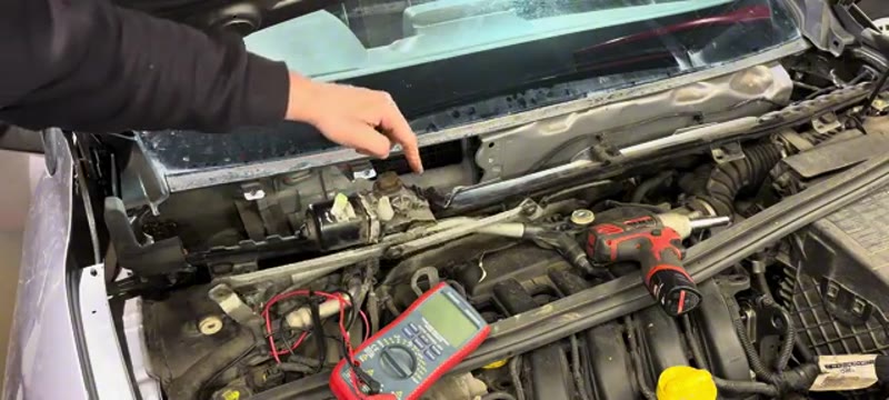 Refitting the repaired wiper motor and linkage back into the Renault Megane