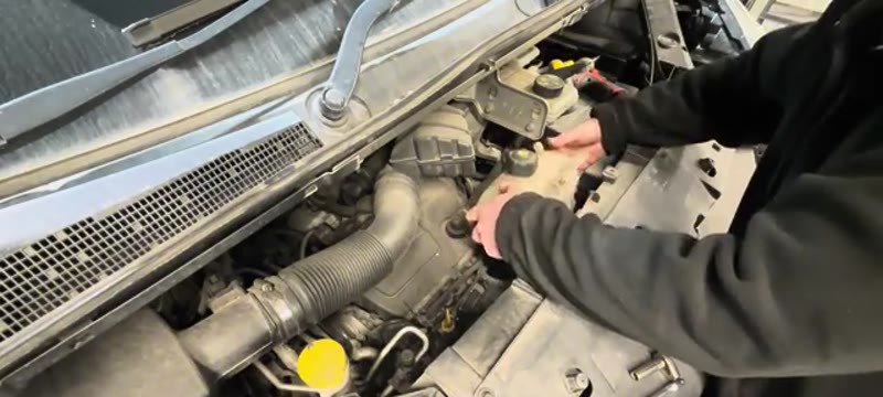 Moving the coolant bottle and oil filler aside in the Renault Trafic engine bay