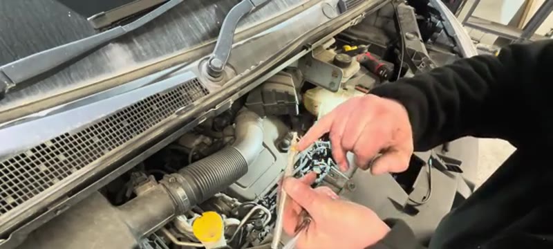 Inspecting a corroded old glow plug removed from the Renault Trafic