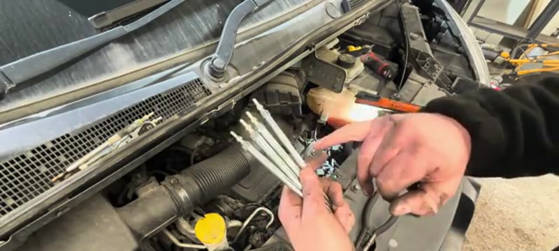 Four new glow plugs ready to fit with anti-seize on the threads