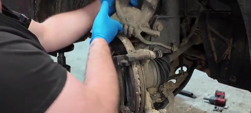 Lifting the brake caliper up and away without straining the brake hose