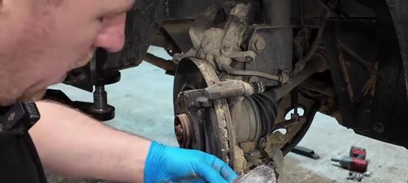 Knocking the worn brake pads out of the carrier on a Renault Trafic