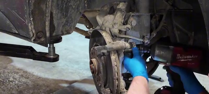 Removing the two 18mm caliper carrier bolts with an impact gun