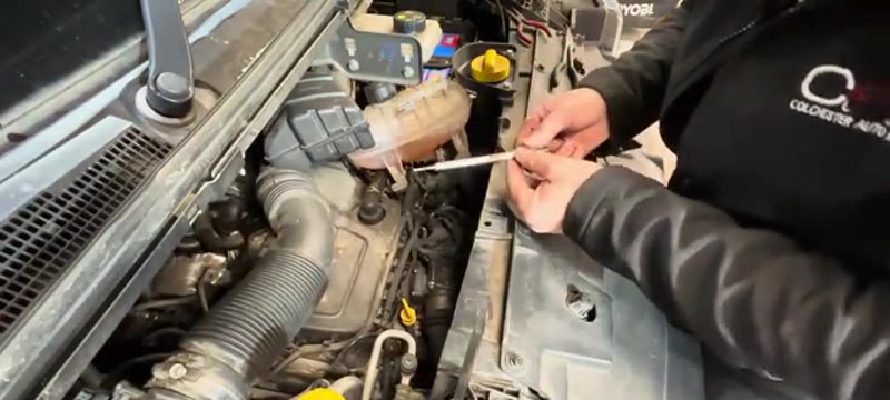 Applying copper grease to the new glow plug threads before fitting to the Trafic