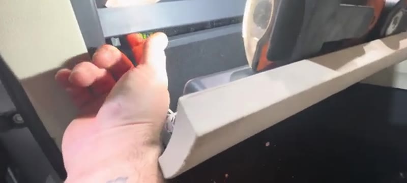 Pulling the rubber tab to release the glove box from its top mounts on the Superb