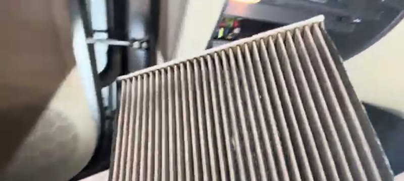 Old dirty pollen filter removed from the housing on a Skoda Superb