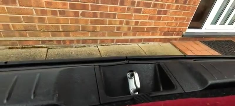 Emergency release lever on the boot latch of a Suzuki Vitara 2015, reached with the rear seats folded down