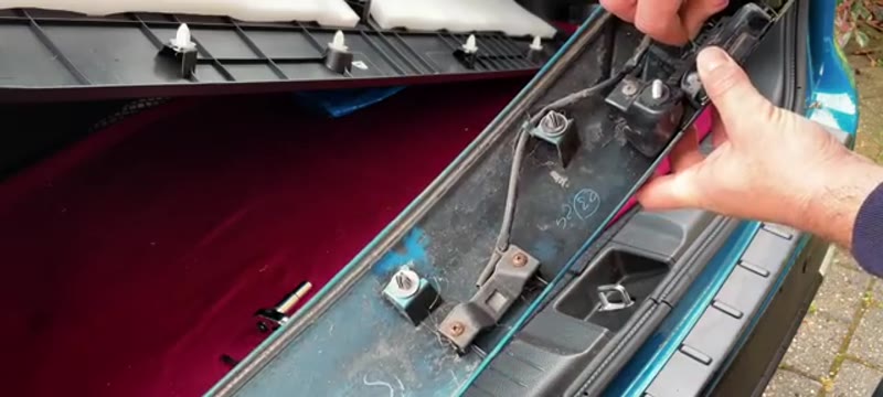 Inspecting the corroded wiring loom on the Suzuki Vitara boot latch mechanism