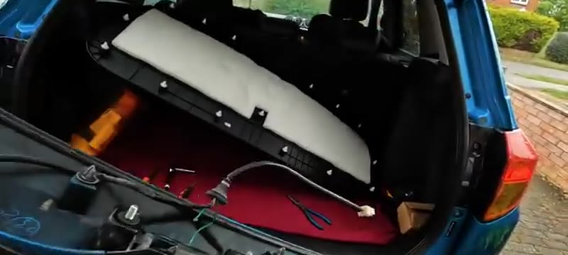 Releasing the wiring clips and lifting the boot latch mechanism away from the Suzuki Vitara tailgate