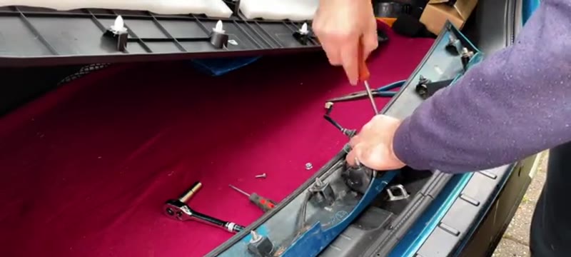 Removing the Phillips screws to strip down the Suzuki Vitara boot switch assembly