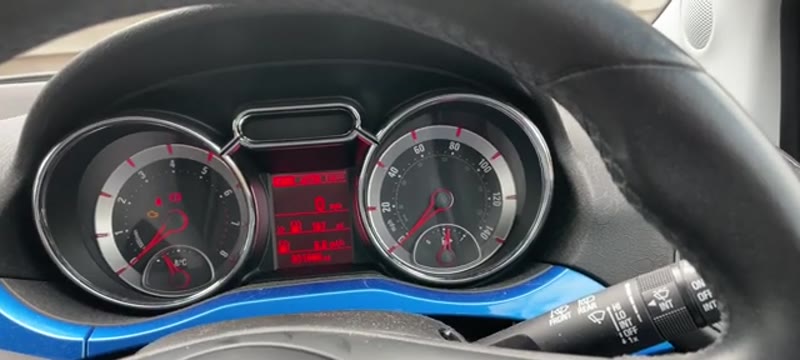 Pressing the END button on the indicator stalk to bring up the display menu on a Vauxhall Adam