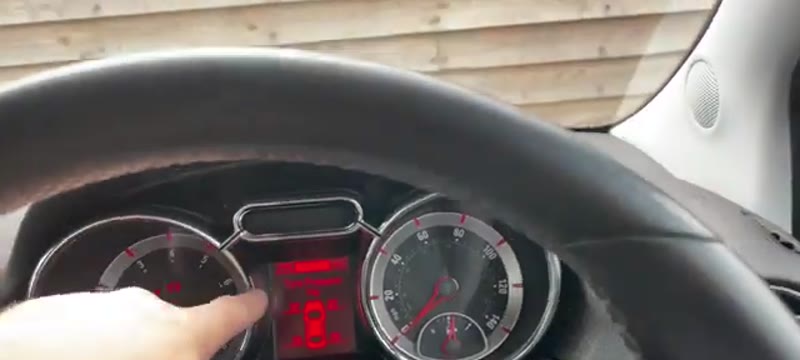 Pressing the MENU button on the stalk to reach the car icon menu on the Vauxhall Adam display