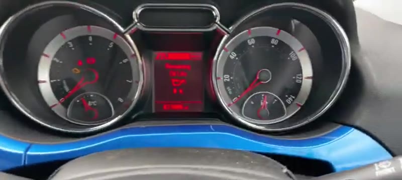 Pressing and holding the END button to begin the service light reset on a Vauxhall Adam