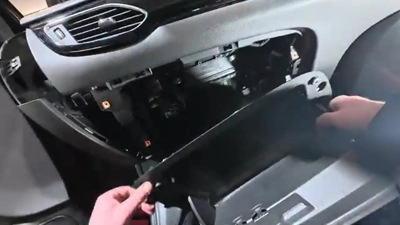 Pulling the glove box free from the dashboard of the Vauxhall Astra