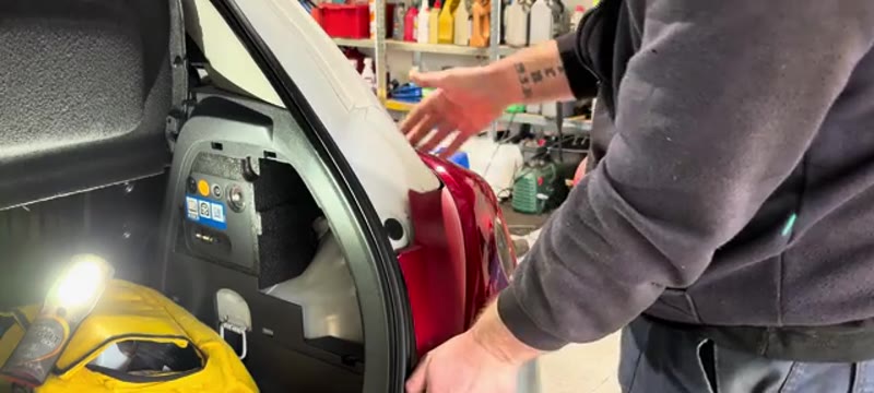 Popping the rear light unit out of the bodywork on the Vauxhall Corsa