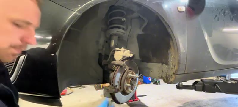 Removing the caliper carrier bolts behind the hub on the Vauxhall Insignia