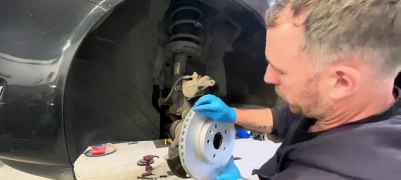 Fitting the new brake disc onto the hub of the Vauxhall Insignia